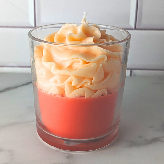 Two-layered candle in a glass container with a white background