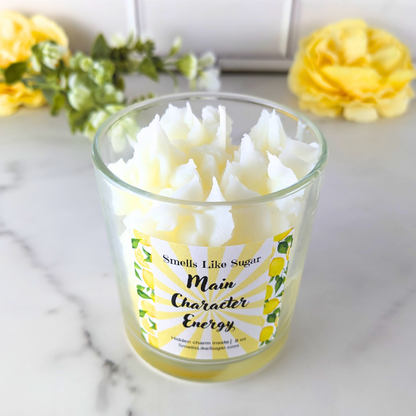Candle in a glass jar with a lemon-themed label.