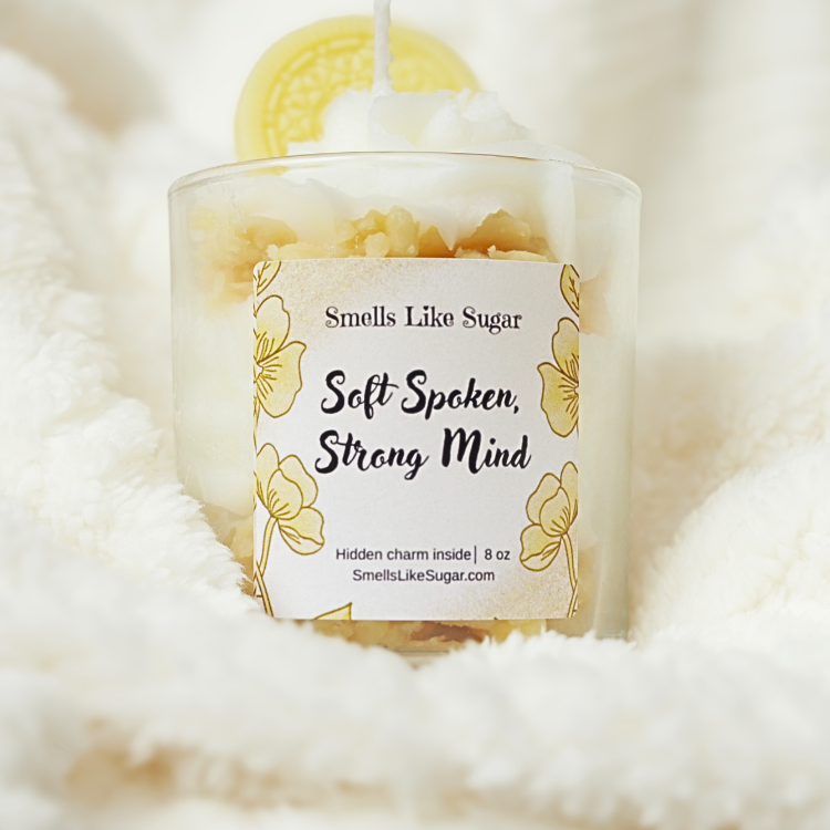 Candle with a label on a fluffy white surface